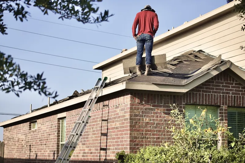 Professional roofer working on a residential roof in Ecorse